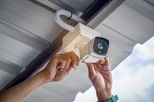 Technician installing CCTV camera system for security area Technician installing CCTV camera system for security area